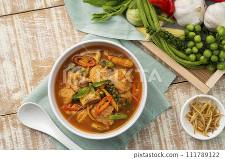 Jungle Curry with clown featherback fishball and vegetable with fingerroot (Gaeng Pa),Thai hot and spicy curry soup without Coconut Milk in white bowl.Top view Jungle Curry with clown featherback fishball and vegetable with fingerroot (Gaeng Pa),Thai hot and spicy curry soup without Coconut Milk in white bowl.Top view 111789122