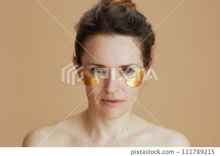 Portrait of modern 40 years old woman with eye patches Portrait of modern 40 years old woman with eye patches 111789215
