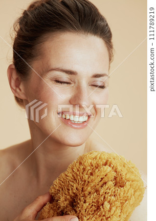 happy young woman with sea sponge happy young woman with sea sponge 111789219