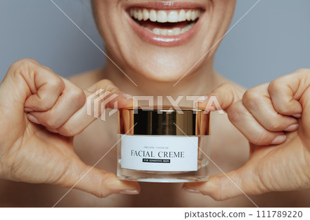 Closeup on woman with cosmetic cream jar Closeup on woman with cosmetic cream jar 111789220