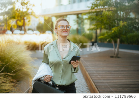business woman in green blouse and eyeglasses using phone business woman in green blouse and eyeglasses using phone 111789666