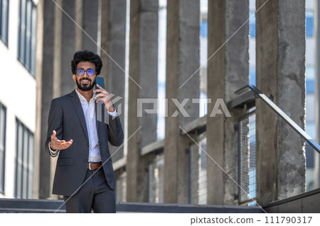 Stylish brunette in elegant suit with phone in hands 111790317