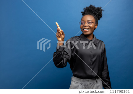 Dark-skinned elegant woman smiling and looking aside Dark-skinned elegant woman smiling and looking aside 111790361
