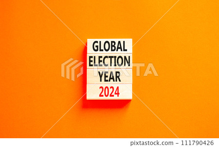 Global election year 2024 symbol. Concept words Global election year 2024 on beautiful wooden block. Beautiful orange table orange background. Business Global election year 2024 concept. Copy space. 111790426
