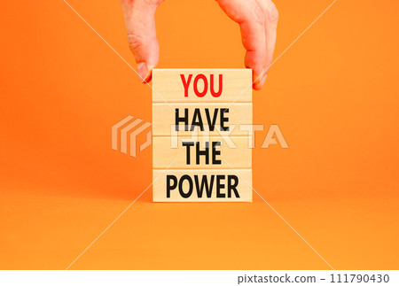 You have the power symbol. Concept word You have the power on beautiful wooden block. Beautiful orange background. Businessman hand. Business motivational you have the power concept. Copy space. 111790430