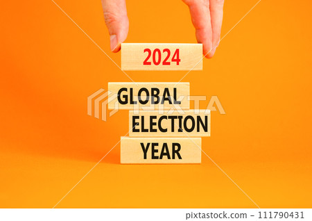 2024 global election year symbol. Concept words 2024 global election year on beautiful block. Beautiful orange table background. Voter hand. Business 2024 global election year concept. Copy space 2024 global election year symbol. Concept words 2024 global election year on beautiful block. Beautiful orange table background. Voter hand. Business 2024 global election year concept. Copy space 111790431