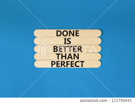 Done is better than perfect symbol. Concept words Done is better than perfect on wooden stick. Beautiful blue table blue background. Business, done is better than perfect concept. Copy space. Done is better than perfect symbol. Concept words Done is better than perfect on wooden stick. Beautiful blue table blue background. Business, done is better than perfect concept. Copy space. 111790441