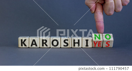 Karoshi yes or no symbol. Concept words Karoshi Yes or No on beautiful wooden blocks. Beautiful grey table grey background. Businessman hand. Business and stop karoshi concept. Copy space. Karoshi yes or no symbol. Concept words Karoshi Yes or No on beautiful wooden blocks. Beautiful grey table grey background. Businessman hand. Business and stop karoshi concept. Copy space. 111790457