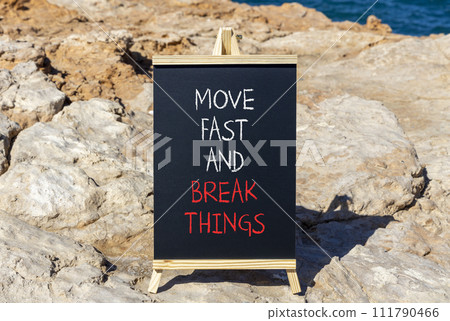 Move fast and break things symbol. Concept words Move fast and break things on beautiful blackboard. Beautiful stone sea background. Business, move fast and break things concept. Copy space. 111790466