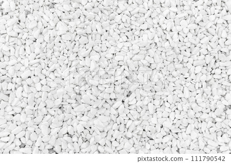 Smooth white pebble, top view, close-up background texture Smooth white pebble, top view, close-up background texture 111790542