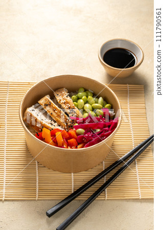 Poke bowl with chicken, peppers, edamame beans and pickled red cabbage.  111790561