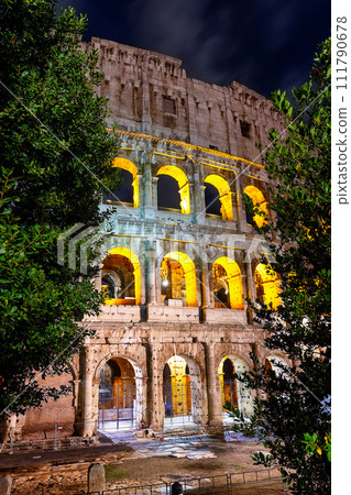 Arches of Rome Colosseum (Flavian Amphiteater) illuminated at night, Rome, Italy. 111790678