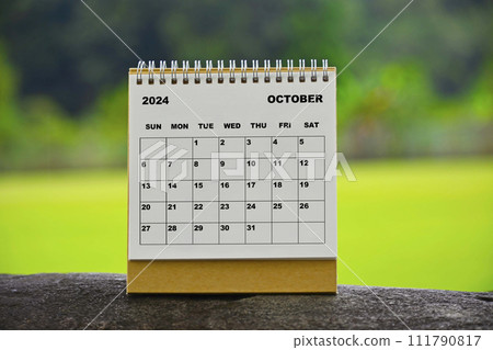 October 2024 white calendar with green blurred background. 111790817