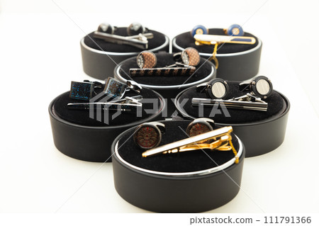 Sets with cufflinks and tie clips on white background. Sets with cufflinks and tie clips on white background. 111791366