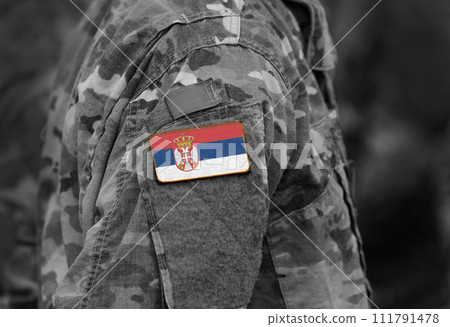Flag of Serbia on soldiers arm (collage). 111791478