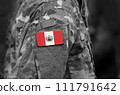 Flag of Peru on soldiers arm. Flag of Peru on military uniforms (collage). 111791642