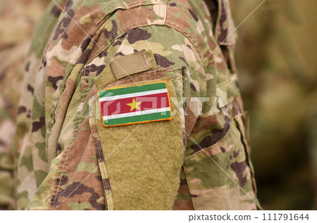 Suriname flag on soldiers arm. Suriname army (collage) Suriname flag on soldiers arm. Suriname army (collage) 111791644