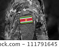 Flag of Suriname on soldier arm. Flag of Suriname on military uniforms (collage). 111791645