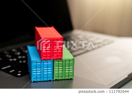 Ship container on laptop keyboard. Trade, economics and transport industry. Production of containers. Import or export. Registration of deliveries and transportation with sea transport operators. 111792044