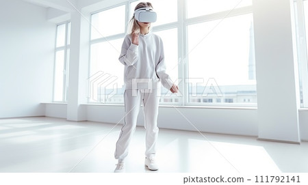 a young girl of European appearance, in casual clothes, in a modern bright room wearing a white VR virtual reality headset. daylight 111792141