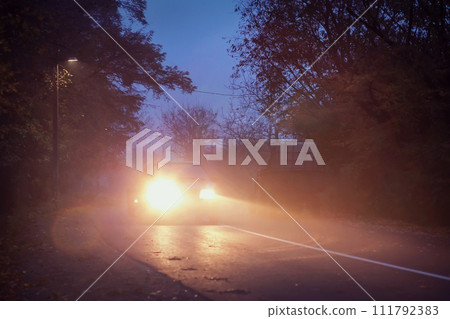 road in the evening, autumn, fog, car on the road, 111792383