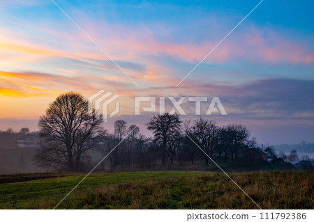 sunset in the field. beautiful autumn foggy landscape in Ukraine sunset in the field. beautiful autumn foggy landscape in Ukraine 111792386
