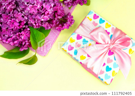 beautiful dark purple fresh lilac on the pink background, purple background, place for text, top view beautiful dark purple fresh lilac on the pink background, purple background, place for text, top view 111792405