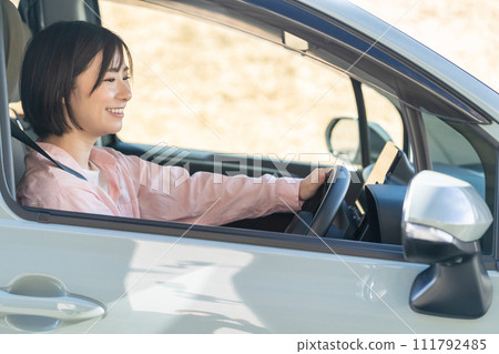 A woman driving a car A woman driving a car A woman driving a car A woman driving a car 111792485