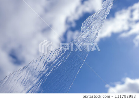 Blue sky and a hand holding thin ice 111792988