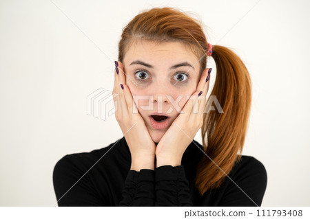 Portrait of serious young woman holding her hands to face thinking concentrated about something. Portrait of serious young woman holding her hands to face thinking concentrated about something. 111793408