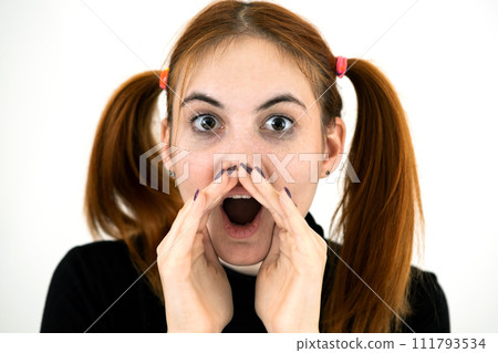 Close up portrait of pretty redhead teenage girl shouting. Close up portrait of pretty redhead teenage girl shouting. 111793534