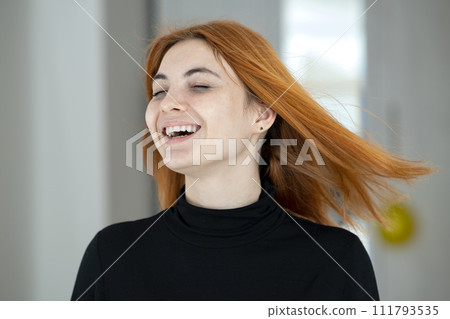 Close up portrait of pretty redhead girl with long wavy hair blowing on the wind. Close up portrait of pretty redhead girl with long wavy hair blowing on the wind. 111793535