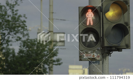 Close up urban city traffic light changing to green from red signal cars to proceed across intersection. Safety for drivers and pedestrians in crosswalk. Traffic light for pedestrians Close up urban city traffic light changing to green from red signal cars to proceed across intersection. Safety for drivers and pedestrians in crosswalk. Traffic light for pedestrians 111794319