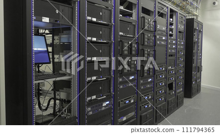 Storage servers are located in the server room of the data center. Back of the server installed in the server room. Many cables are connected to a powerful computers 111794365