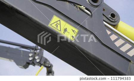 A forestry machine loads a log truck at the site landing. Forest machine down logs 111794383