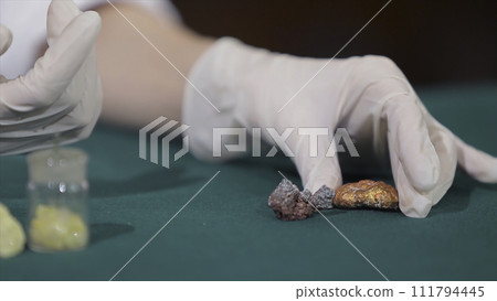 Scientist or archaeologist holding stones or minerals in hands. People with samples of archeology in the hands of Scientist or archaeologist holding stones or minerals in hands. People with samples of archeology in the hands of 111794445