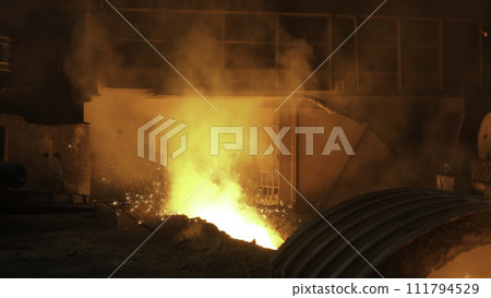 Liquid metal from blast furnace. Liquid iron from ladle in the steelworks 111794529