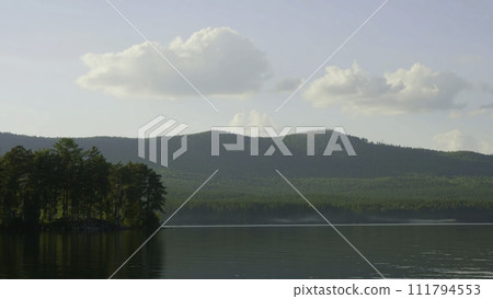 Summer landscape with river, cloudy sky, forest and sun timelapse. summer landscape with river and blue sky time lapse. Amazing clouds on the lake coast 111794553