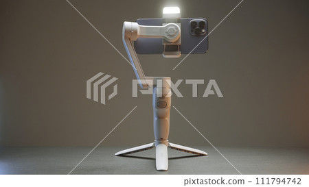 Professional tripod for phone. Action. Assembly model of tripod for professional shooting on phone. White tripod of new model on isolated background Professional tripod for phone. Action. Assembly model of tripod for professional shooting on phone. White tripod of new model on isolated background 111794742