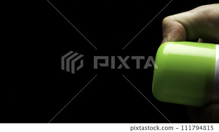 Closeup of spray can spraying aerosol insecticide or fragrance mist into the air in slow motion on black background. Air freshener on black background Closeup of spray can spraying aerosol insecticide or fragrance mist into the air in slow motion on black background. Air freshener on black background 111794815