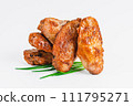 Chicken wings fried until half cooked, semi-finished product with fresh herbs on a white background. Fast food. Quick cooking at home. Copy space.Fast cooking.Fast homemade food. 111795271