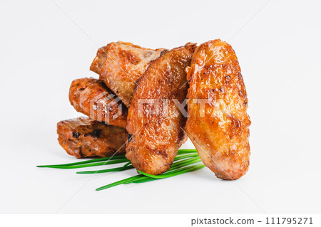 Chicken wings fried until half cooked, semi-finished product with fresh herbs on a white background. Fast food. Quick cooking at home. Copy space.Fast cooking.Fast homemade food. Chicken wings fried until half cooked, semi-finished product with fresh herbs on a white background. Fast food. Quick cooking at home. Copy space.Fast cooking.Fast homemade food. 111795271