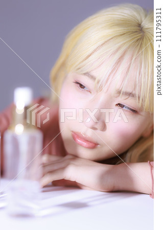 Young woman looking at cosmetics Young woman looking at cosmetics 111795311