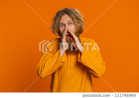 Caucasian young man whisper news rumors holding hands near mouth share gossip quiet keep my secrets Caucasian young man whisper news rumors holding hands near mouth share gossip quiet keep my secrets 111798969