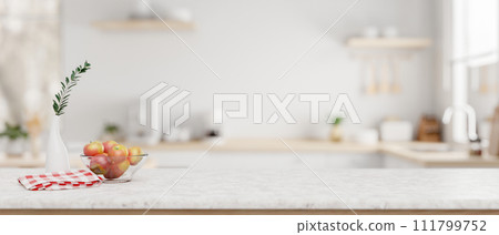 A white marble kitchen countertop with empty space for product display in a modern white kitchen. 111799752