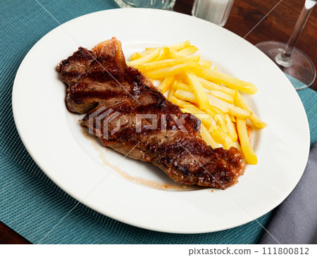 Tasty grilled beef tenderloin with french fries served Tasty grilled beef tenderloin with french fries served 111800812