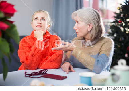 Home quarrel between mom and daughter during christmas closeup 111800823