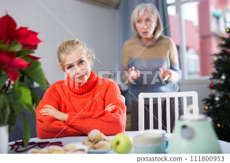 Mature woman quarrels with her adult daughter 111800953
