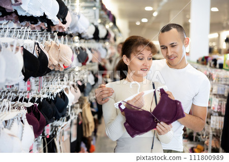 Young couple choosing nice brassiere in clothing store 111800989