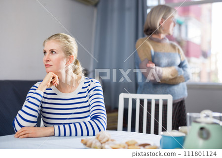 Elderly mother is unhappy with her adult daughter during domestic quarrel Elderly mother is unhappy with her adult daughter during domestic quarrel 111801124